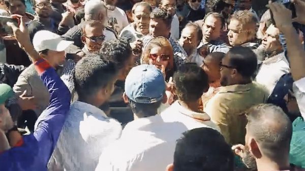 Crowd engaged in heated confrontation.